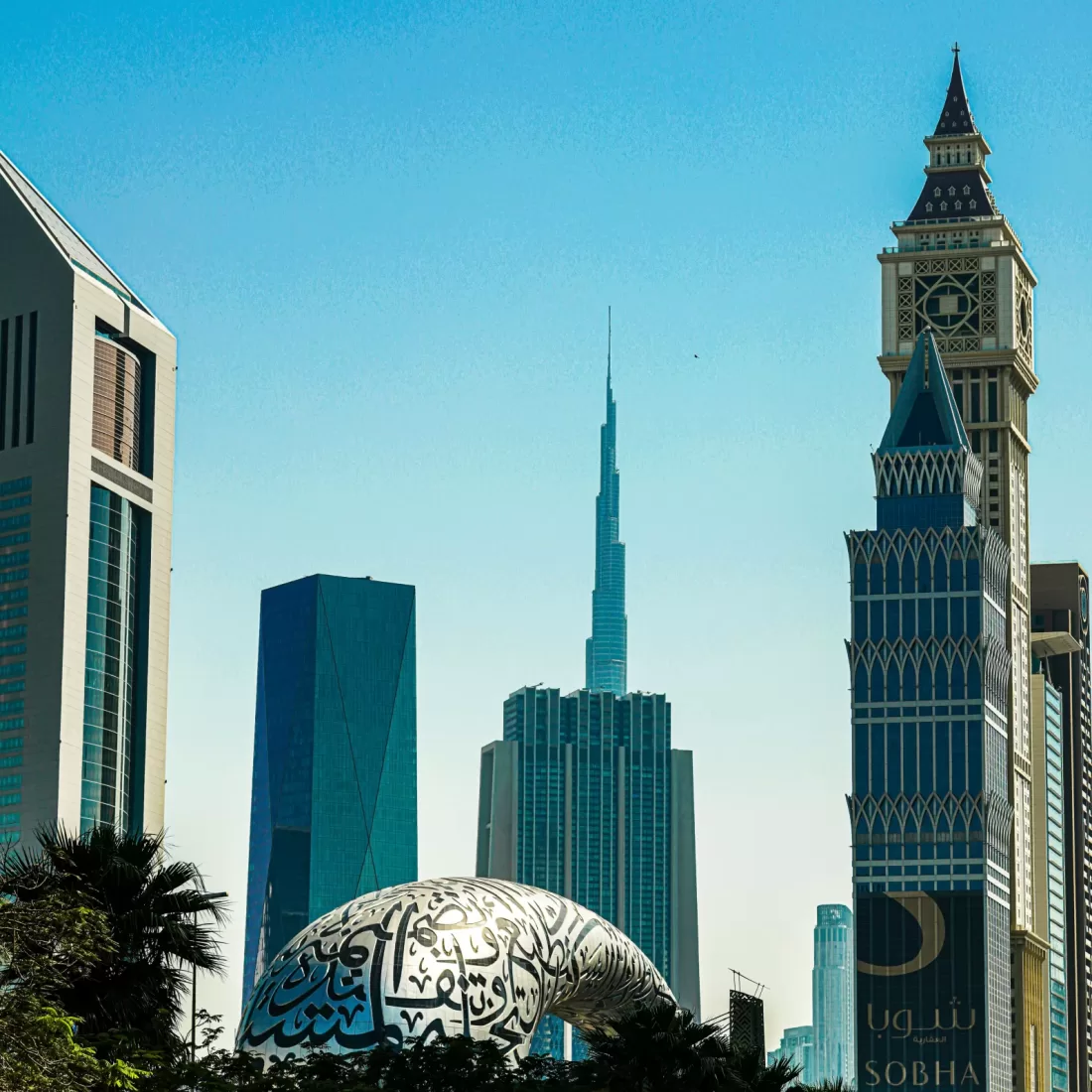A stunning view of Dubai's modern skyline featuring the Burj Khalifa and distinctive architecture under a clear blue sky.